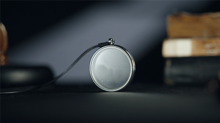 Lightweave by TCC Magic, showing a round clear pendant with a silver-colored rim and black necklace cord